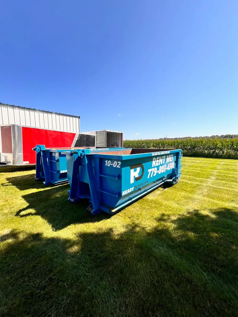 Blue Ready Dumpster containers on a lawn