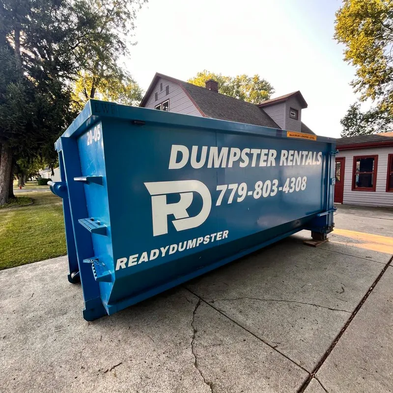 Blue Ready Dumpster container on a residential driveway