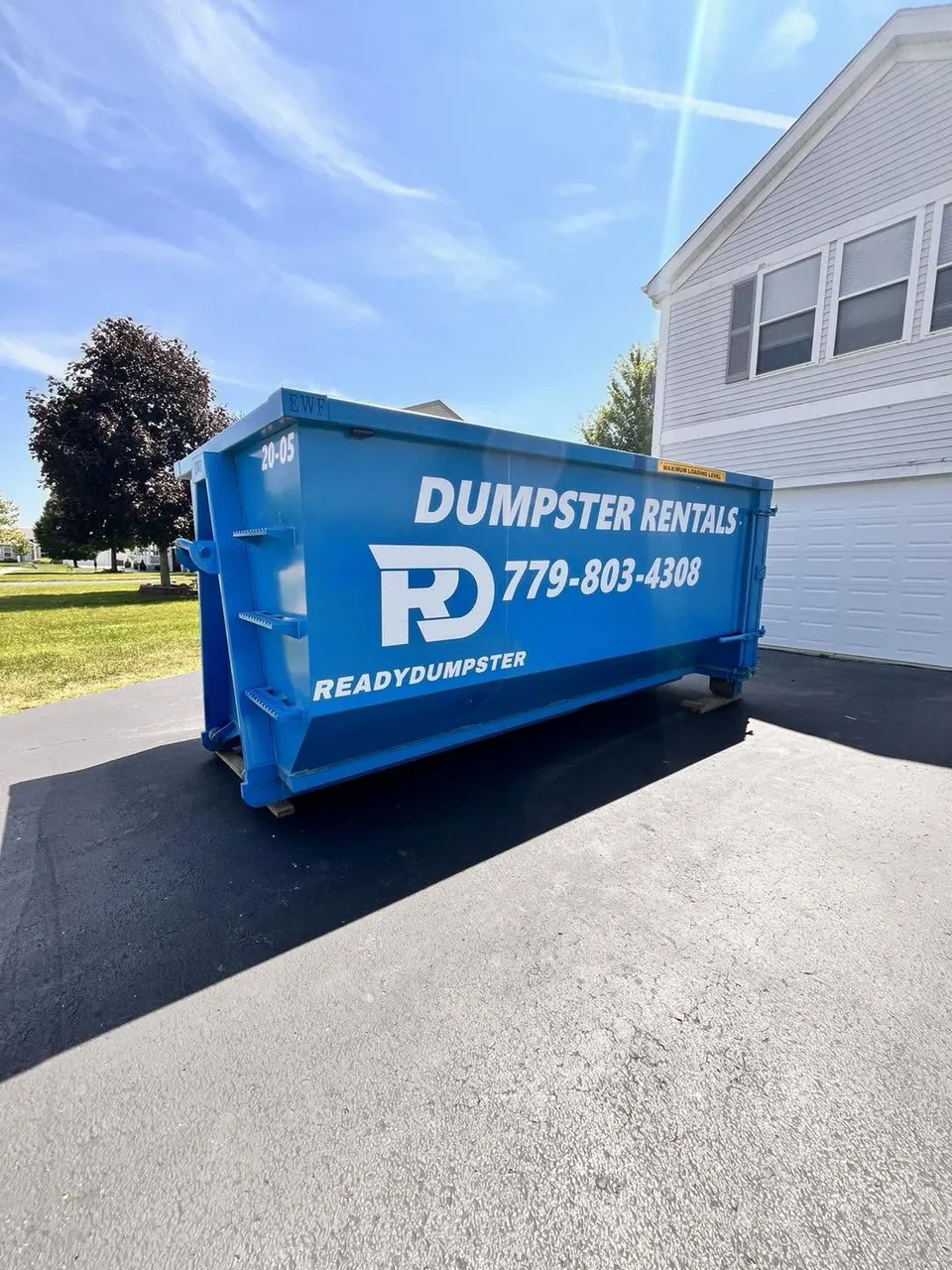 Blue Ready Dumpster container on a residential driveway